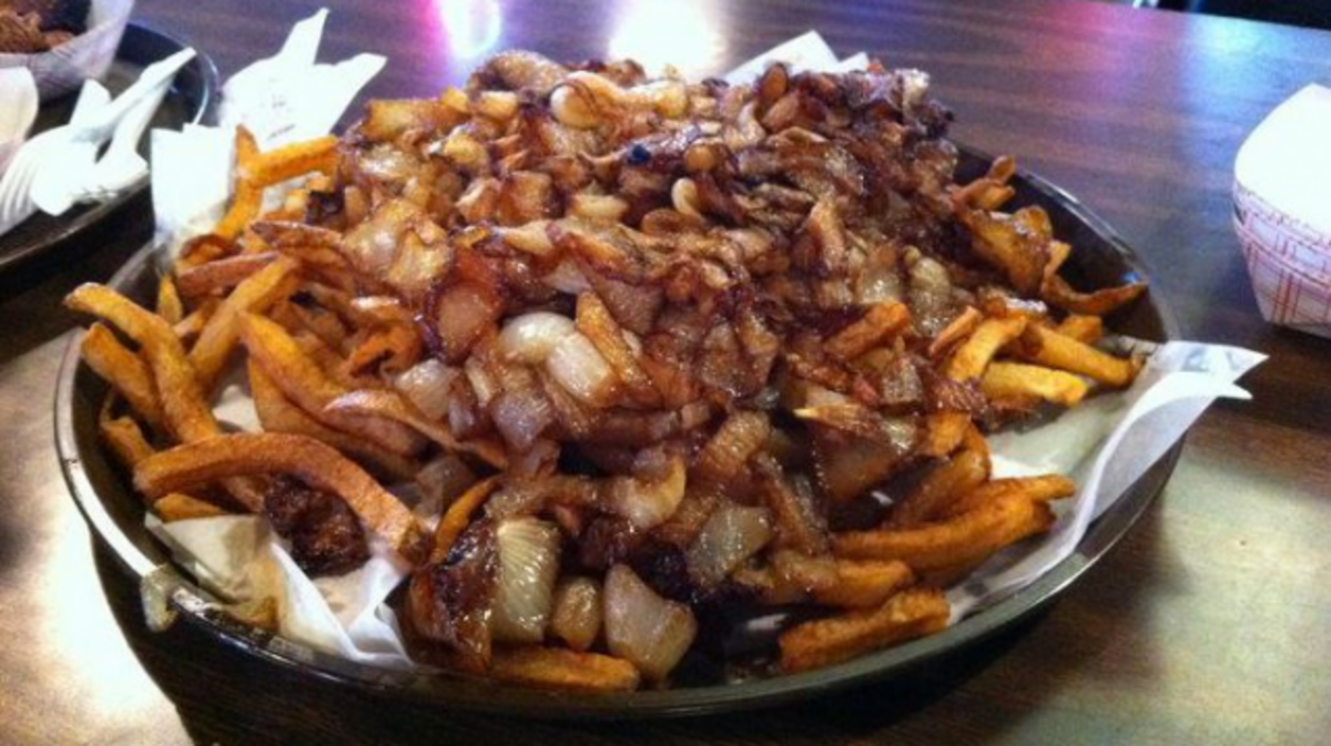The fries with onions at Railhead Smokehouse in Fort Worth are not for the delicate.