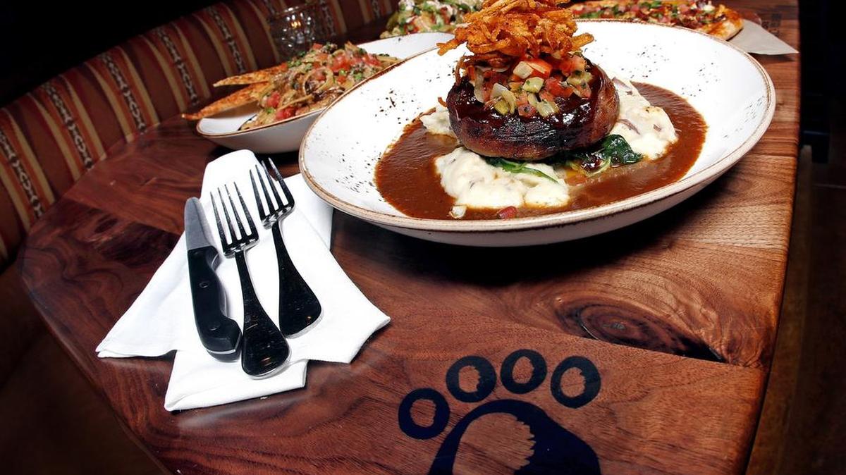 Tables at Lazy Dog Restaurant & Bar are stamped with a signature paw print.