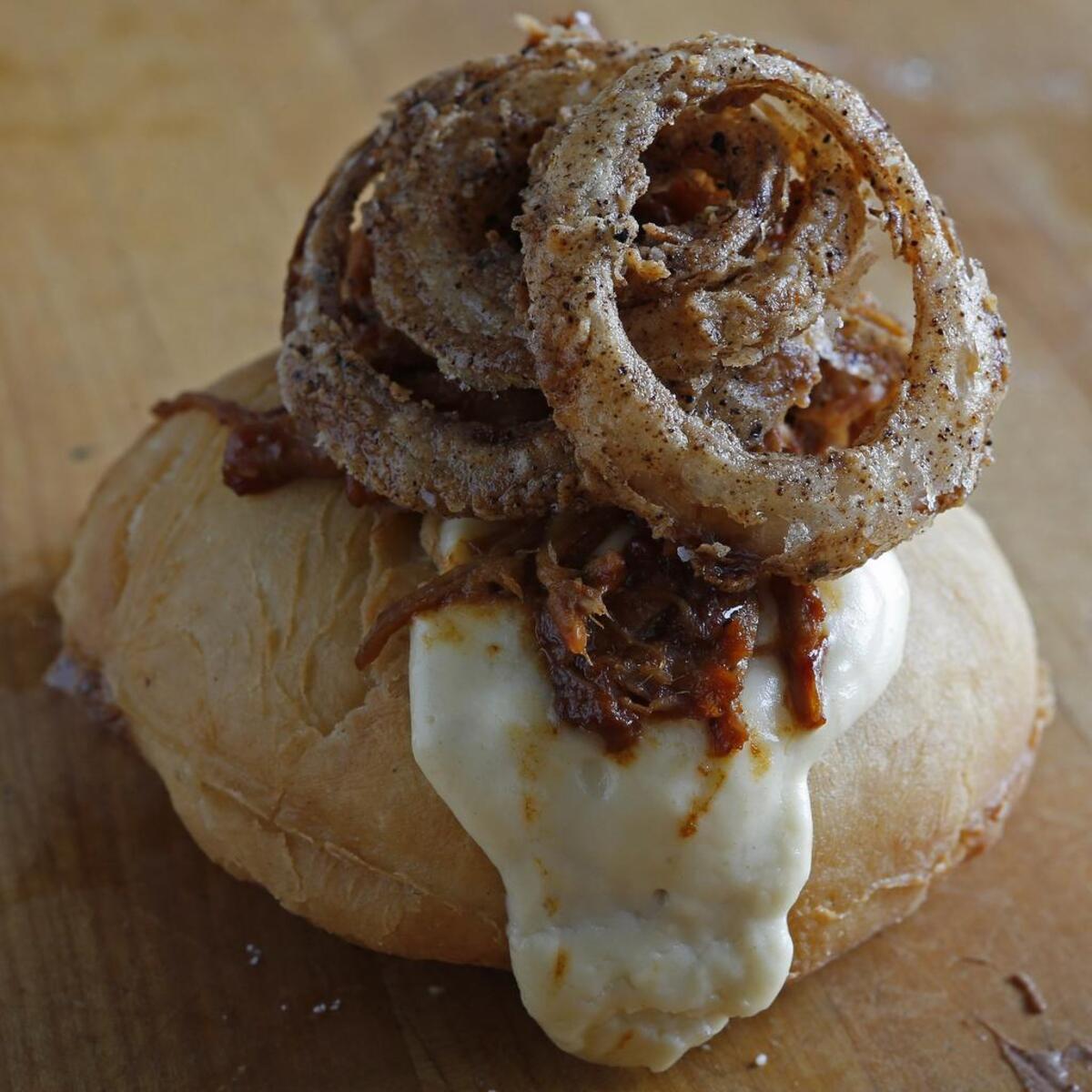 BBQ pulled pork, jalapeno gravy with onion rings doughnut at Chef Tim Love’s Back Dough.