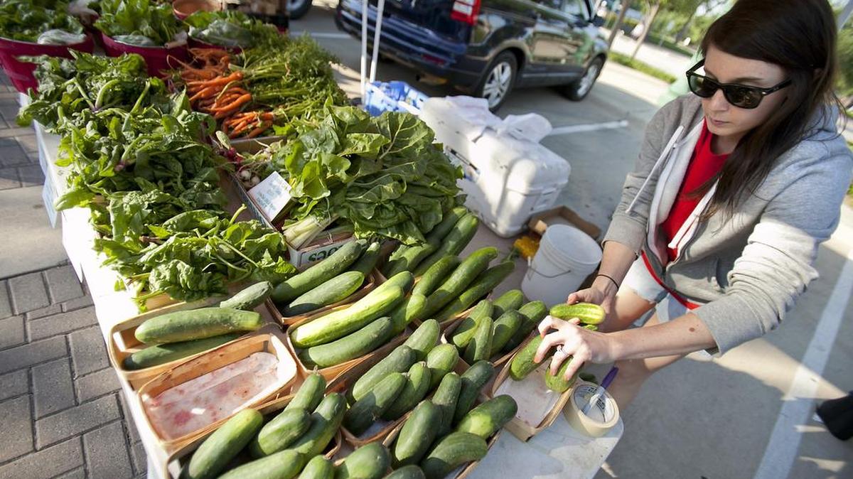 Cortney Copp sorts produce last summer at a Keller Farmers Market stand.