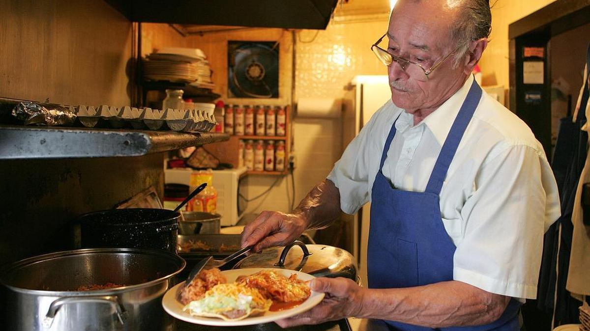 Santos Aguilera, of Aguilera’s Cafe, cooks in 2006 at the north Fort Worth cafe, which had almost nothing outside indicating that it was a restaurant.