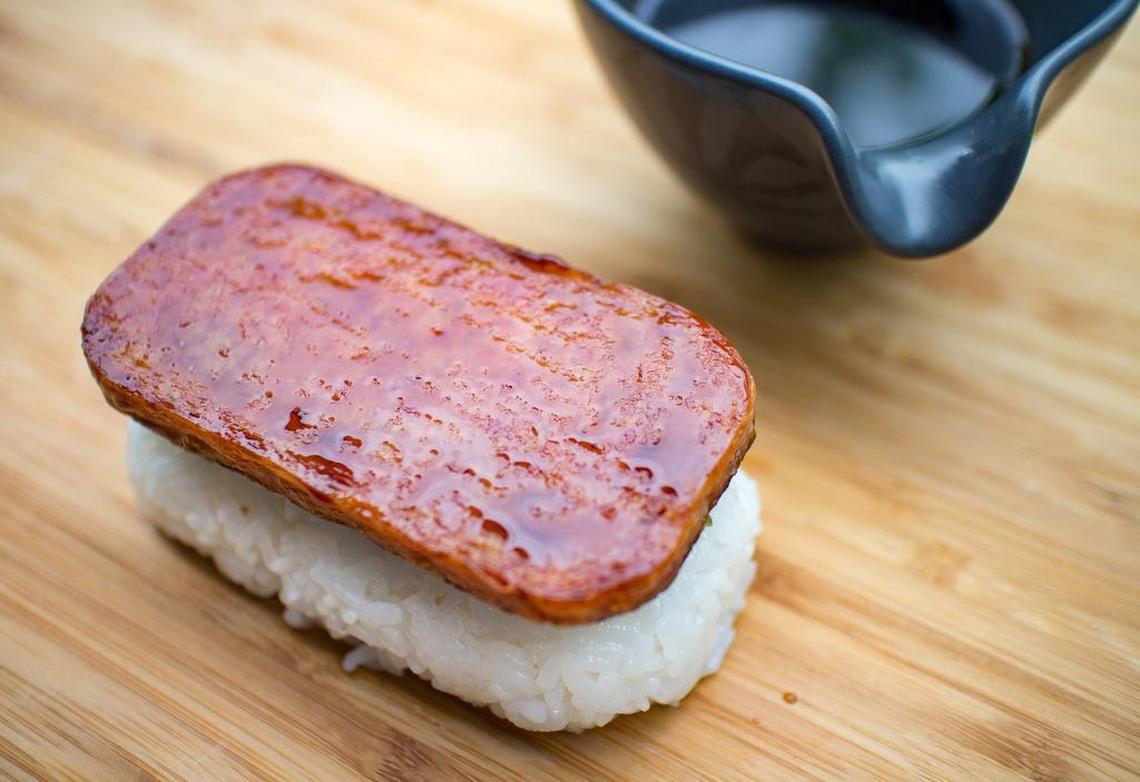 Crispy fried Spam placed on top of rice block with pickled cactus, then brush with some of the Dr. Pepper sauce on top.
