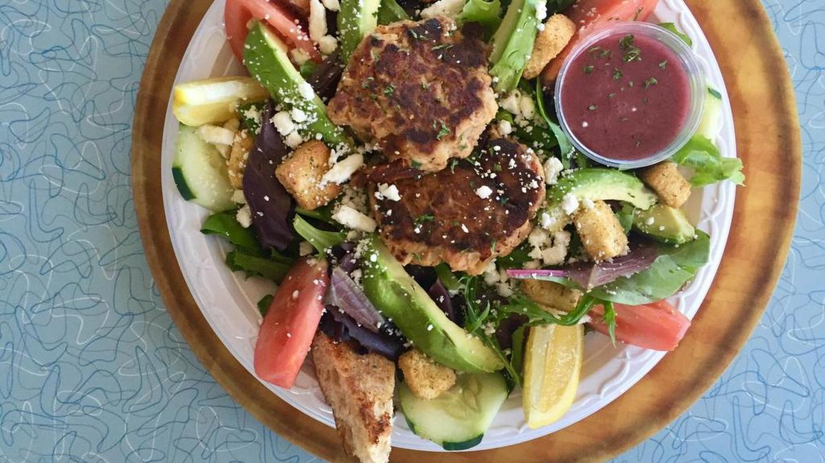An avocado-feta “sister salad” with berry vinaigrette and Danny Badillo’s house salmon cakes at M & O Grill.
