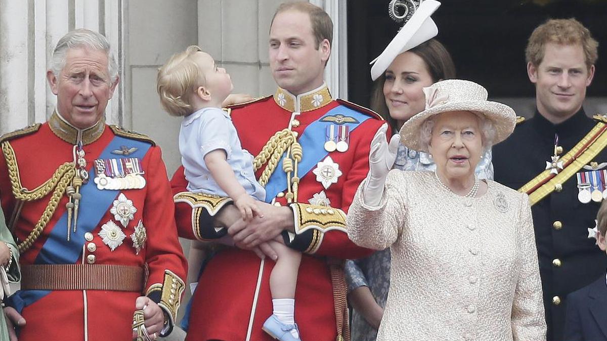 Britain’s Prince William holds his son Prince George, with Queen Elizabeth II, second from right, Kate, Duchess of Cambridge, the Prince of Wales, left, and Prince Harry, right, during the Trooping the Colour parade at Buckingham Palace in London, June 13, 2015.