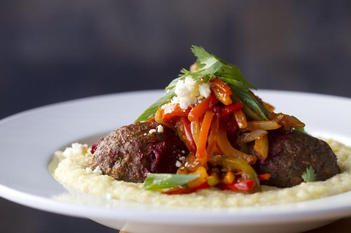 Spicy lamb meatballs on creamy polenta with piperade at M Bistro on Tuesday, March 21, 2017.
