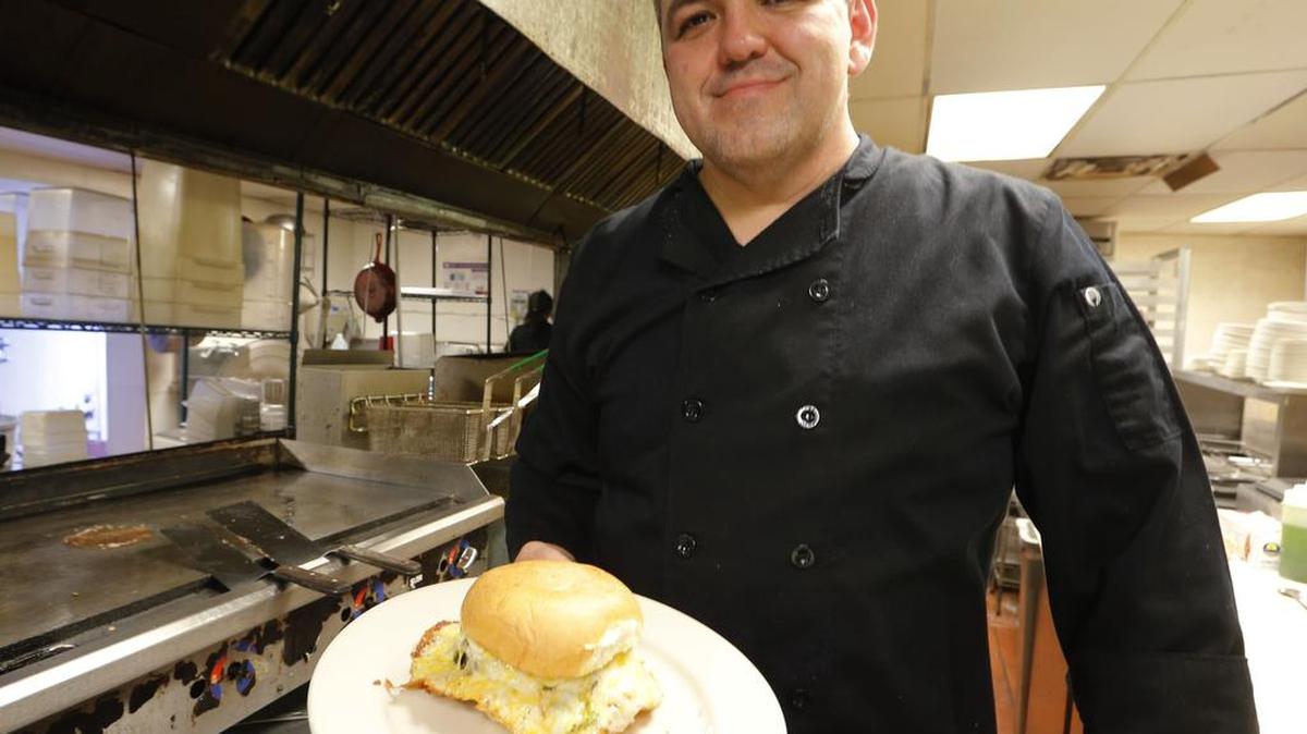 Carlos Rodriguez with his Fuego Burger in a 2015 photo taken at the now-closed Salsa Fuego. Rodriguez has joined AngMar Companies, which owns Fat Daddy’s in Mansfield and is planning to expand its restaurant holdings.