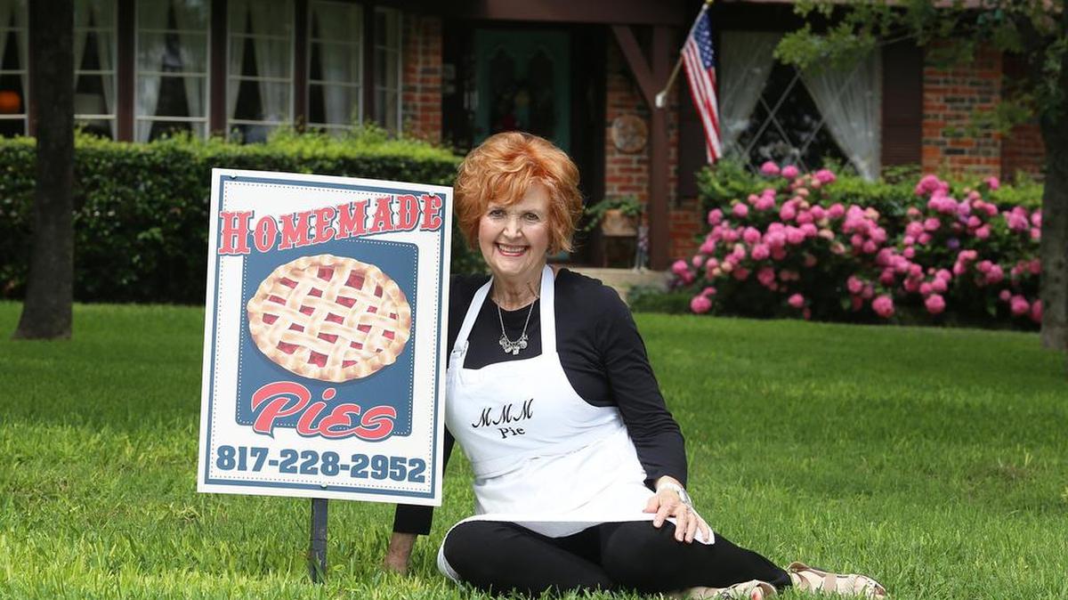 Martha McCormick sits on her front lawn in Keller with a sign that lets people know that she bakes pies for her home business.
