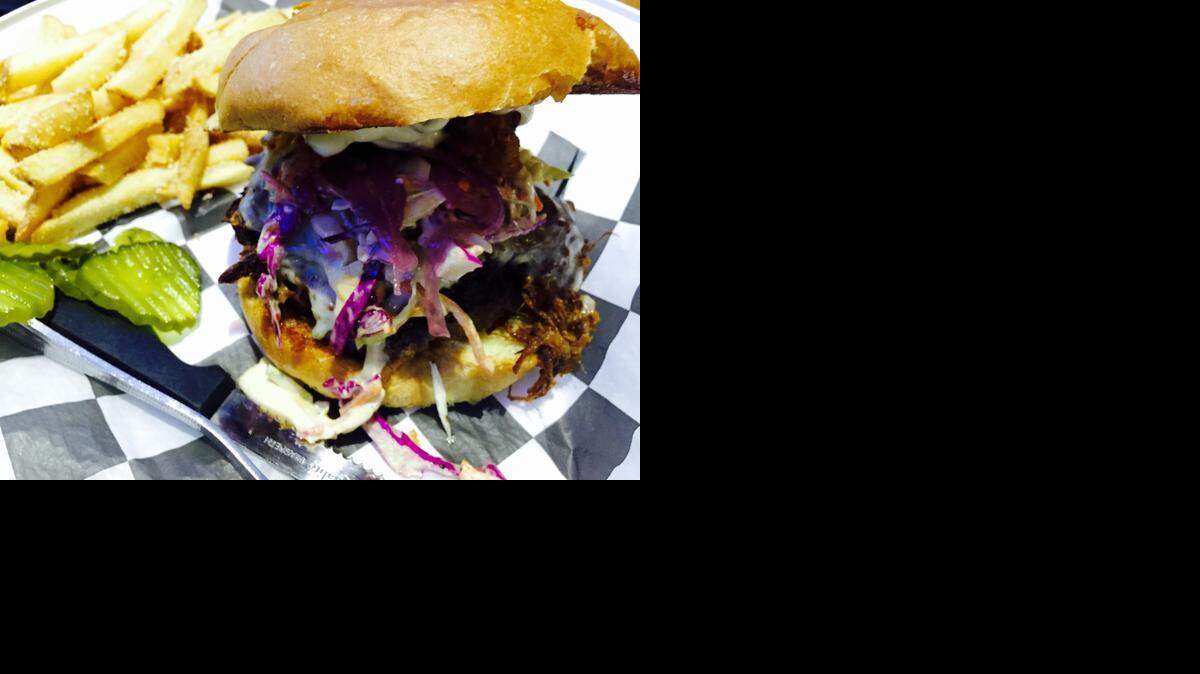 
“The Duke” at Brewsters is a pork-and-bacon cheeseburger with TCU purple-red onions.
