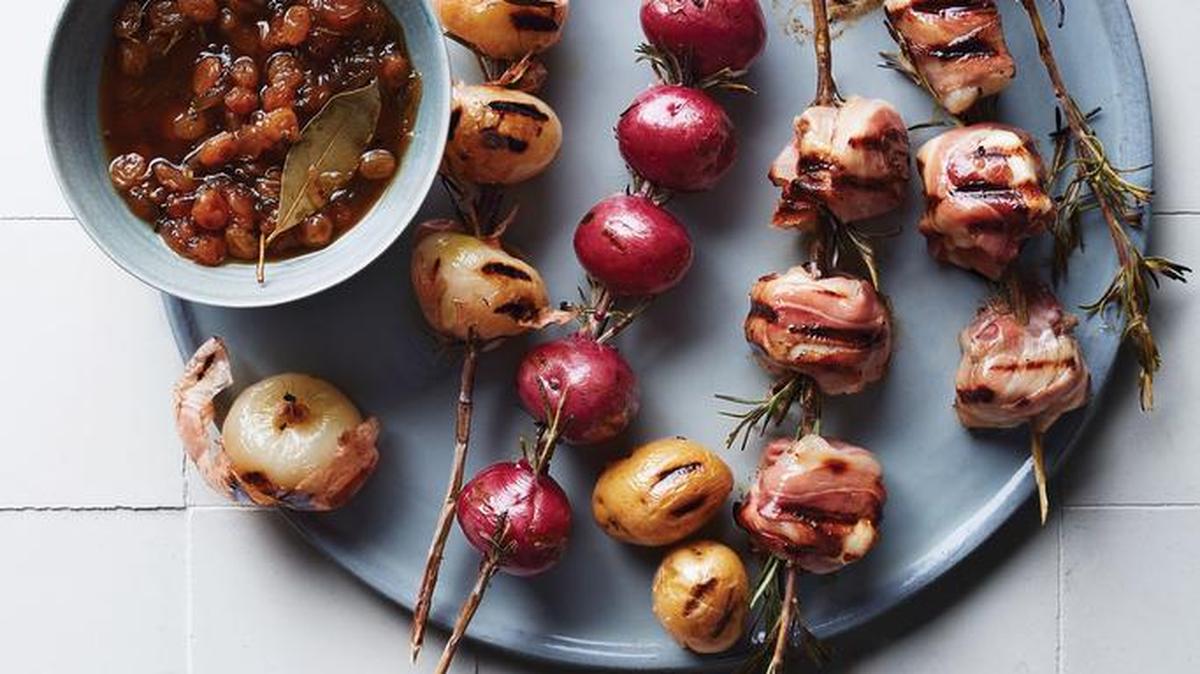 If you have a rosemary plant, snip off the lower sturdy branches. If you don't have one on hand, use wooden skewers for the swordfish, potato and onion skewers with golden raisin agrodolce, and put a handful of store-bought sprigs directly on the fire.