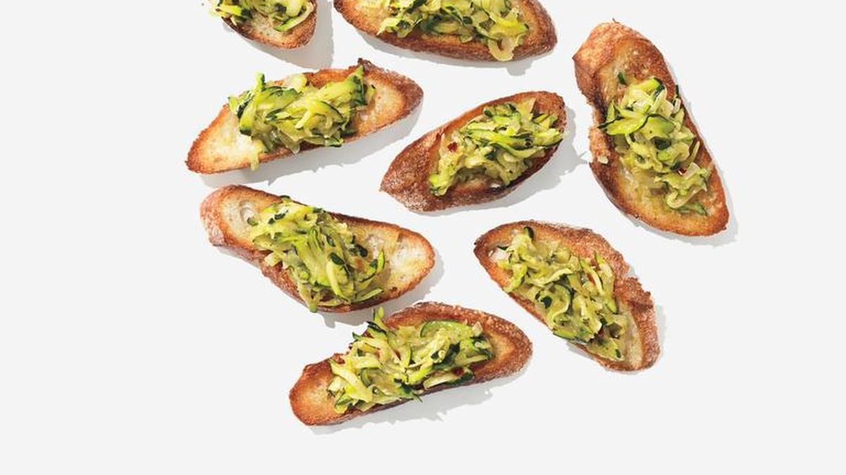 Elegant and easy, sauteed grated squash atop toasted baguette slices makes a perfect appetizer.