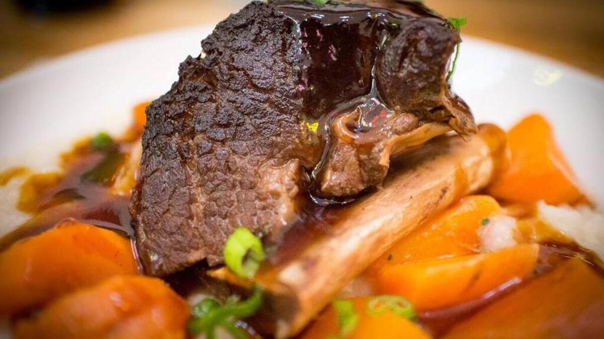 Braised short rib with rice porridge and roasted tomatoes with a black garlic teriyaki at Tokyo Cafe in Fort Worth