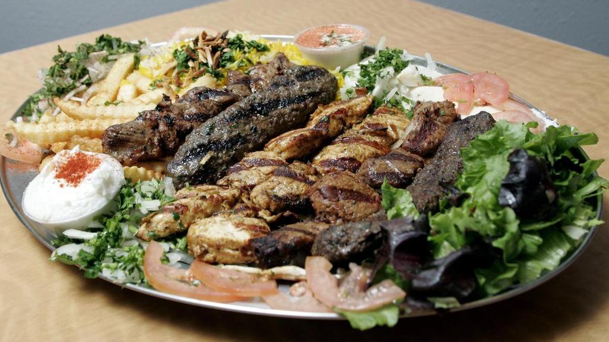 Combo plate for two at Gyro & Kabob Grill in Fort Worth: french fries, rice, hummus, shish kabob, shish tawook, shish kafta and soup or salad.