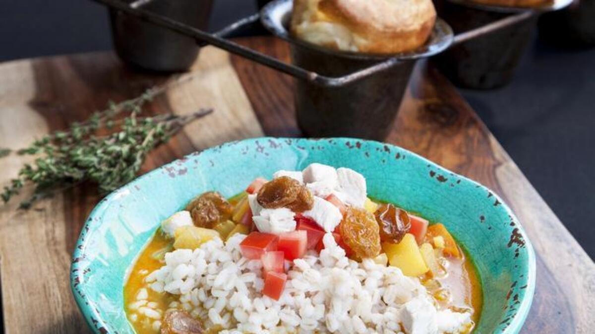 This mulligatawny stew has flavorful additions like coconut milk, apples and aromatic spices. Gruyere and black pepper popovers are a comforting accompaniment.