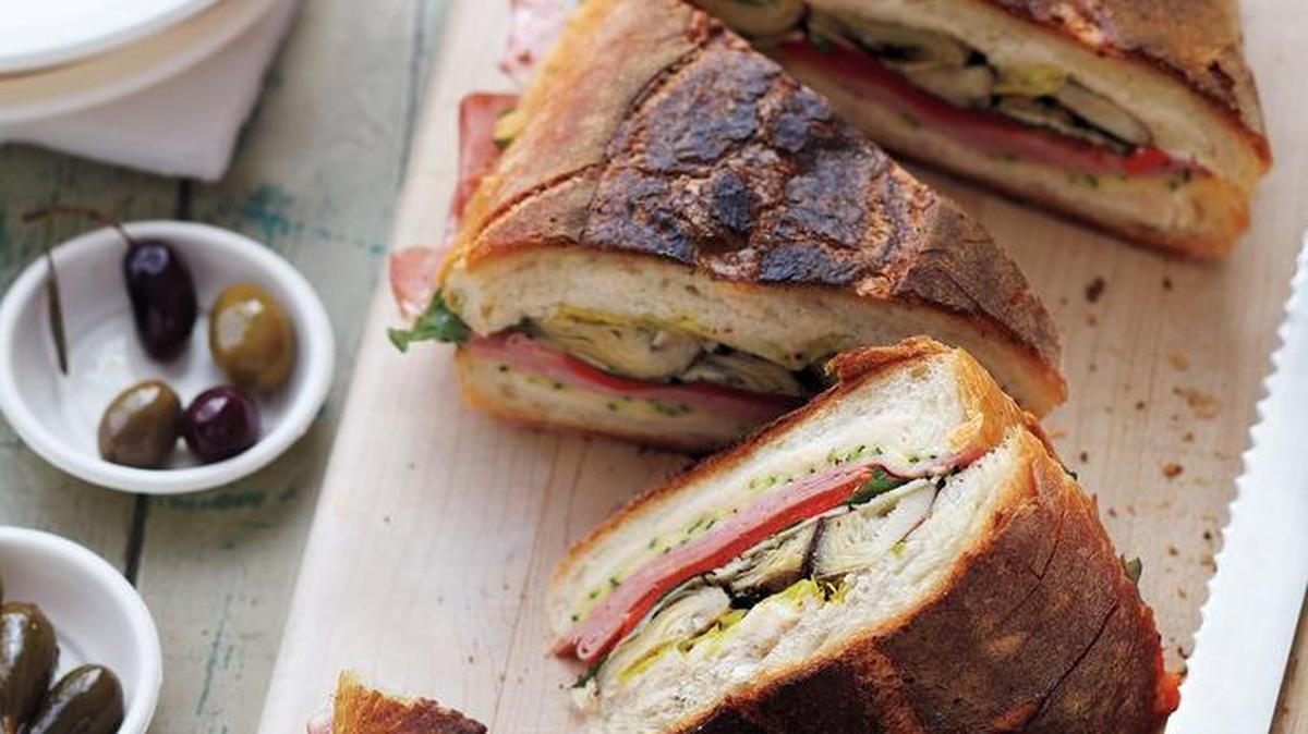 
 Press for Success: Make this antipasto sandwich ahead of time. Pressing it in the refrigerator (or in the bottom of your picnic basket) allows the flavors to mingle. 
