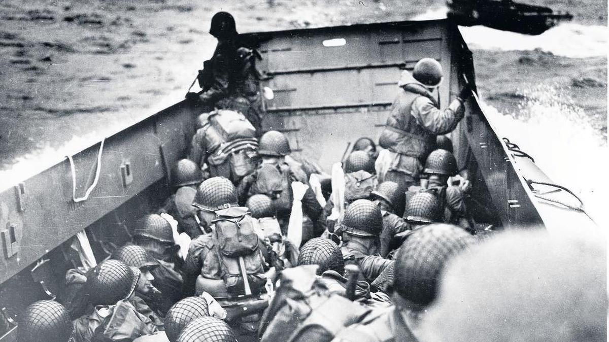 In this June 6, 1944, file photo, Allied troops crouch in a landing craft as it nears Omaha Beach in Normandy, France, on D-Day.