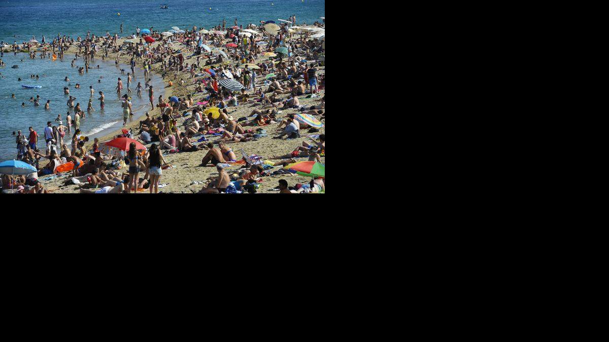 
 Tourists and locals alike flock to beaches around the city of Barcelona, some of which are dotted with distinctive architecture. 
