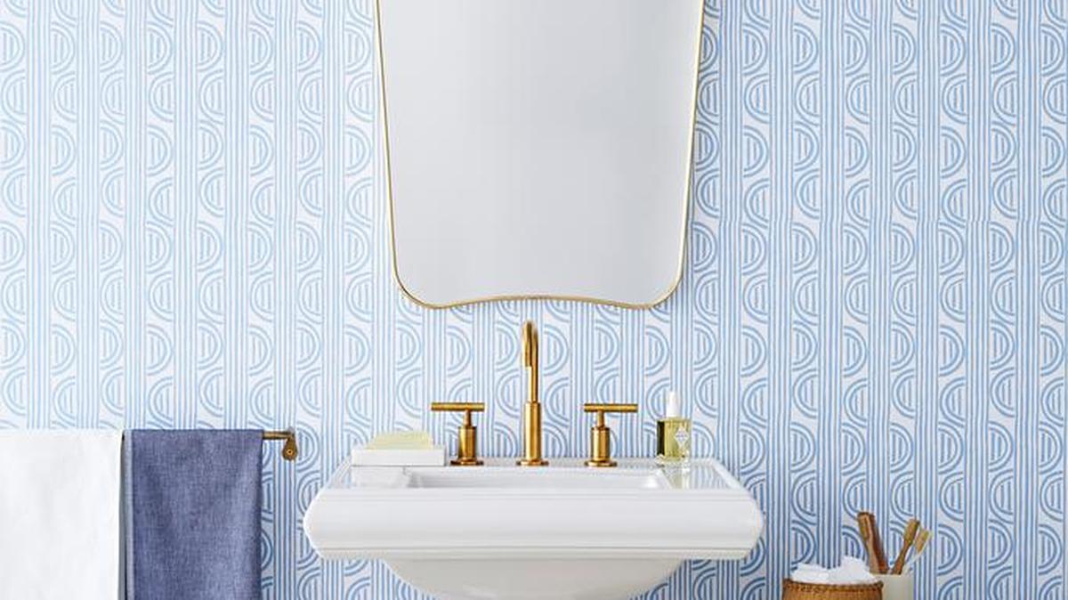 Wallpaper dresses up even a small bathroom. (See sourcing details in Martha’s column.)