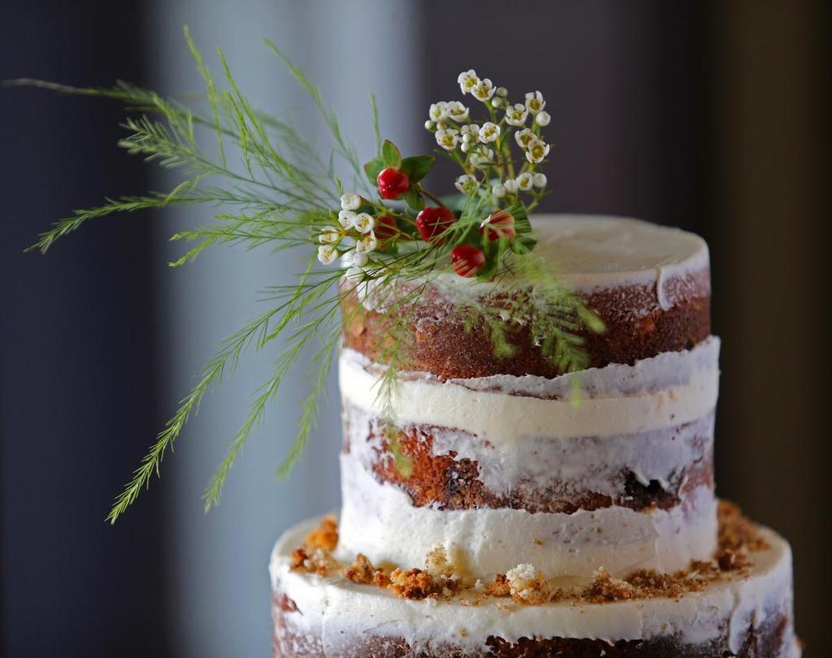 A 2015 file photo of a two-tier, cinnamon roll-flavored, wintery iced cake with wintery floral and fruits created by Heidi Allison, owner of Sugar Bee Sweets in Arlington. Allison will be one of the Tarrant chefs featured on Food Network's upcoming "Dallas Cakes."