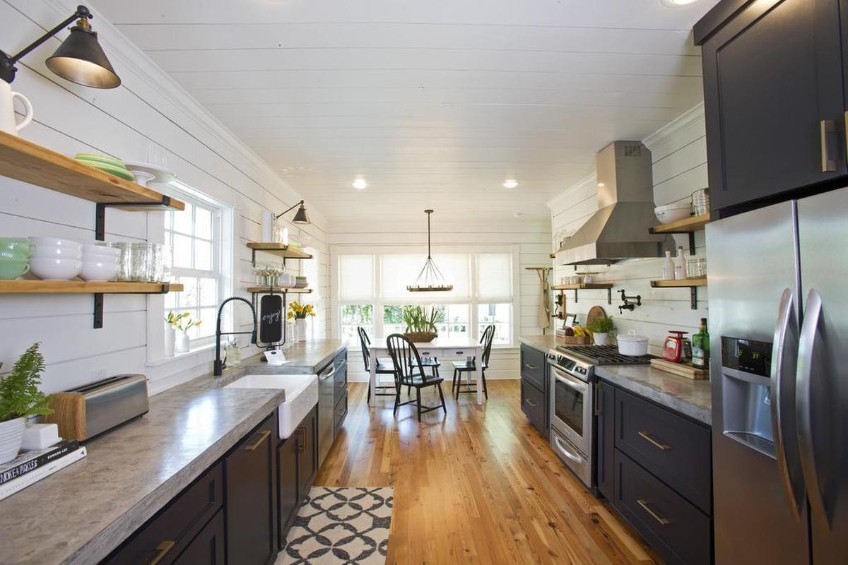 The kitchen, with stainless steel appliances and concrete countertops, allows guests to store groceries and cook meals.