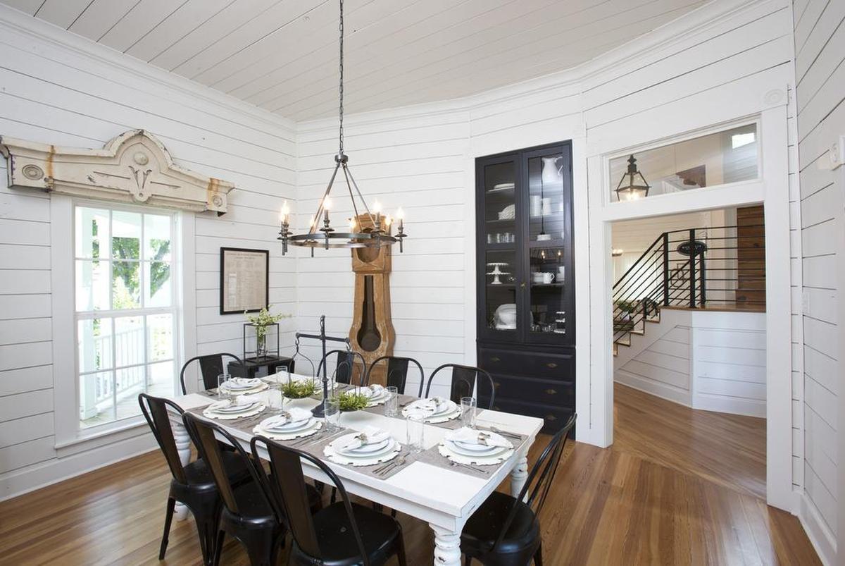 Furnishings in the dining room include an antique grandfather clock case and rustic table in distressed white.