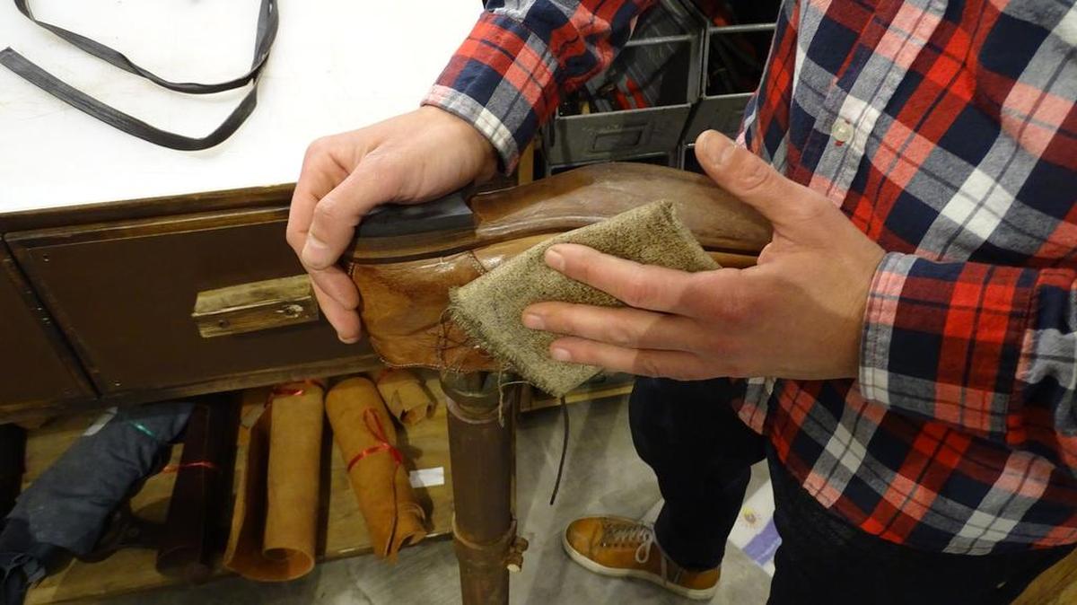 Benheart shopkeeper Simone Razzino hand finishes one of the many unique Italian shoes available in the Florence store.