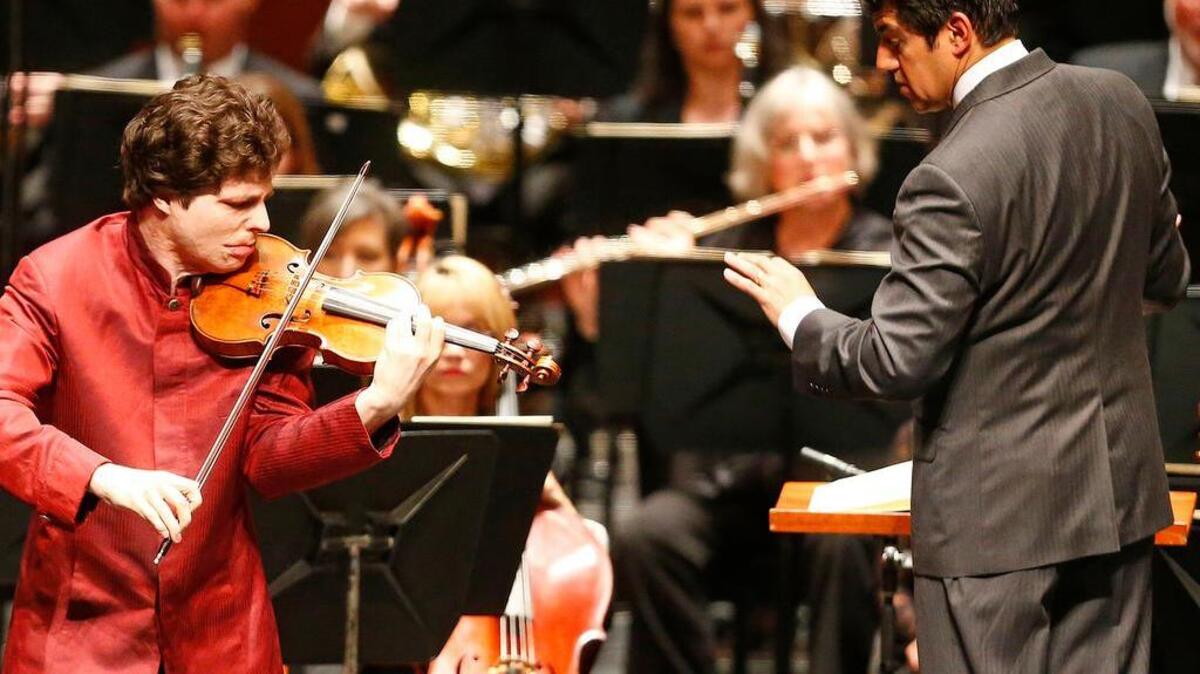 In a file photo, violinist Augustin Hadelich performs with the Fort Worth Symphony Orchestra, conducted by Miguel Harth-Bedoya. Hadelich will perform with the symphony at SHIFT: A Festival of American Orchestras on April 10 at the Kennedy Center for the Performing Arts in Washington, D.C.