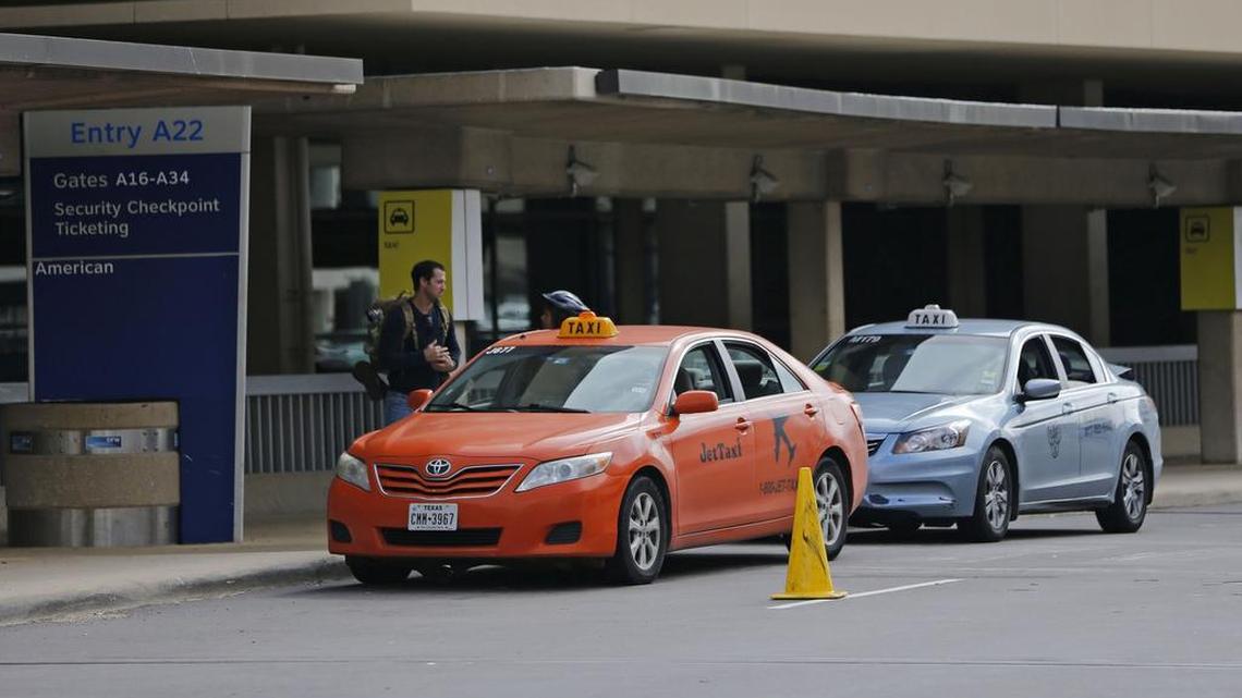 Taxis line up outside Terminal A at DFW Airport.