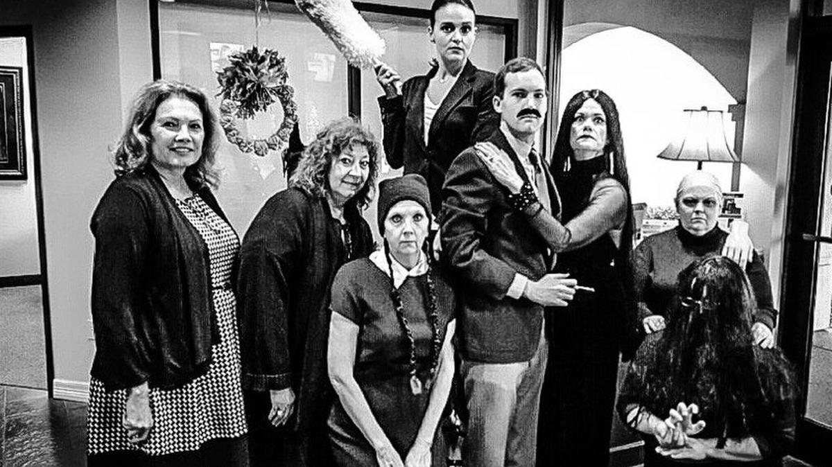 Despite their stoic appearance, co-workers at Alamo Title Co. in Fort Worth had fun pulling off The Addams Family.