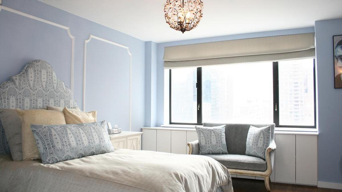 A Serenity blue bedroom paired with white creates a sense of Hollywood glam.