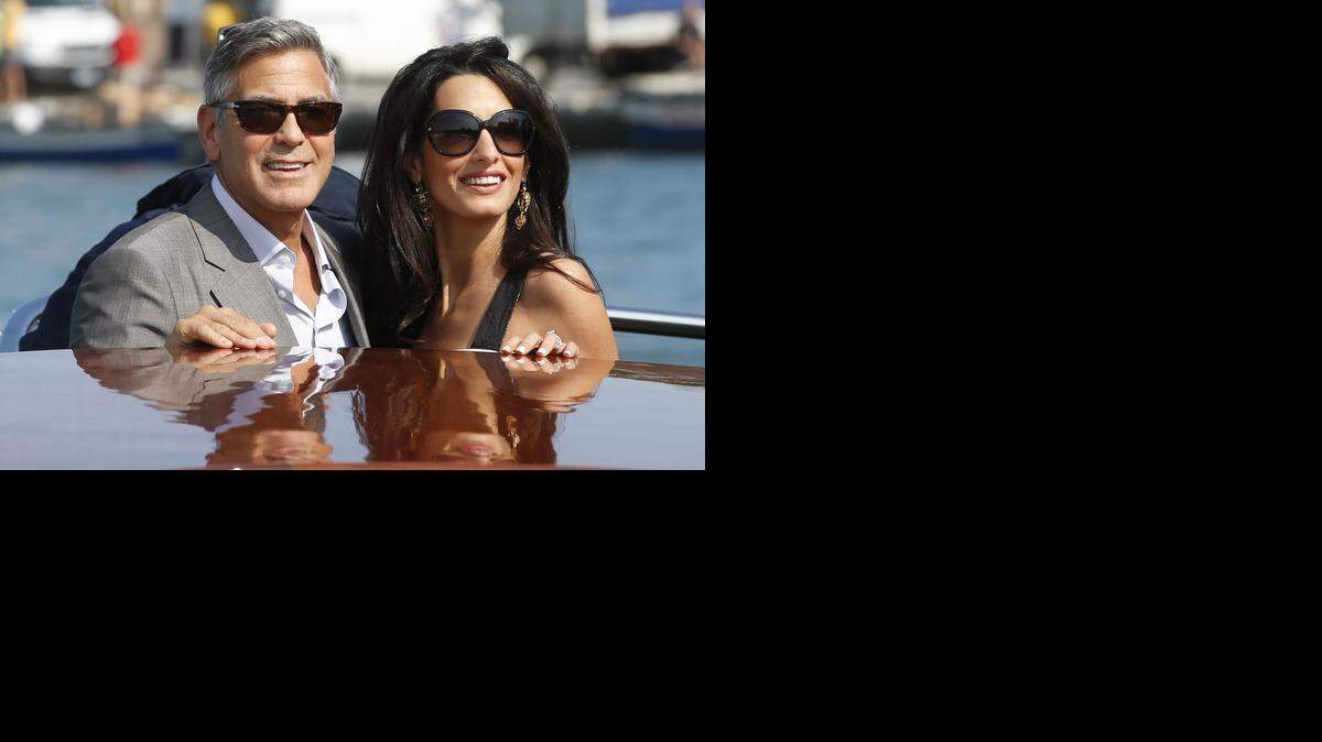 
FILE - In this Sept. 26, 2014 file photo, George Clooney, left, and Amal Alamuddin arrive in Venice, Italy. Clooney, 53, and Alamuddin, 36, married in Venice, one of the world’s most romantic settings. (AP Photo/Luca Bruno, File).
