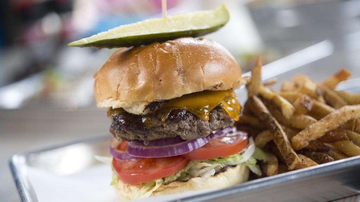 The Dive Burger at the Dive Oyster Bar has standard toppings on the bottom, allowing for more sauce interplay on top.