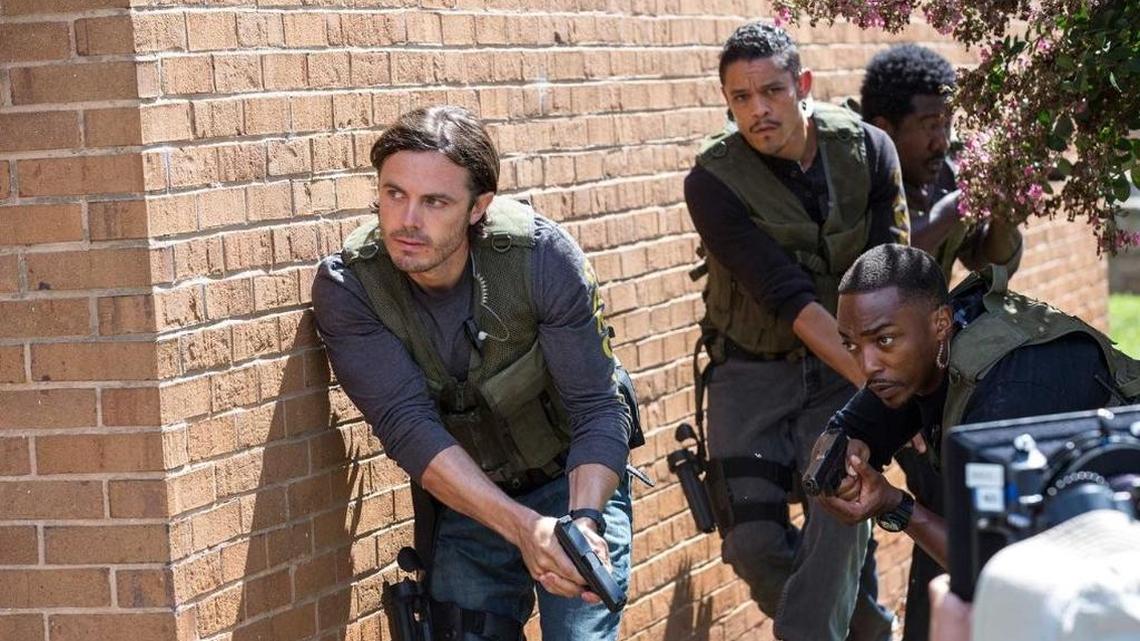 Casey Affleck (front left) and Anthony Mackie (front right) star in ‘Tripl 9.’