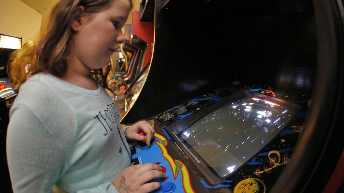 Caroline Toomey (age 10) on a vintage Galaga video game at Tornado Terry’s in Keller, a long-time video game arcade.