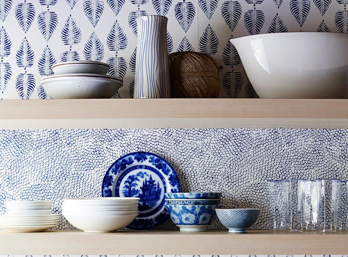 Since the floating shelves hide the wallpaper edges, there’s no need to be ultraprecise about trimming it to line up perfectly.