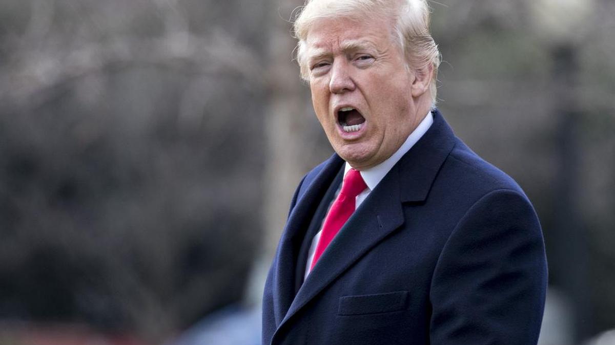 President Donald Trump, photographed shouting to members of the media outside the White House, contributed directly and indirectly to Dictionary.com’s list of top words of 2017.