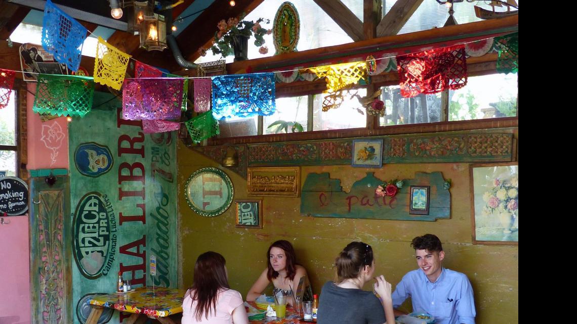 
Diners chow down at patio tables at Por Que No? Taqueria on North Mississippi Avenue. 
