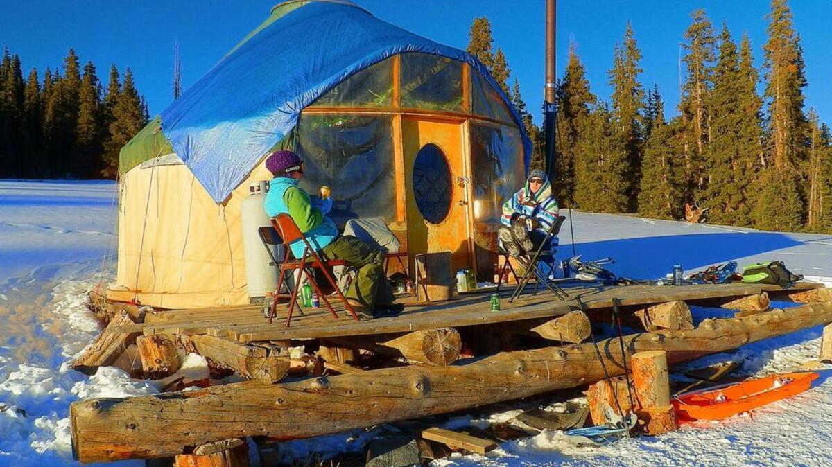 Skiers bask in the winter sun in 2013 at the Rambouillet Yurt, part of the Hinsdale Haute Route system in Colorado’s San Juan Mountains. With the sun reflecting off the snow, sunscreen is essential for a yurt trip.