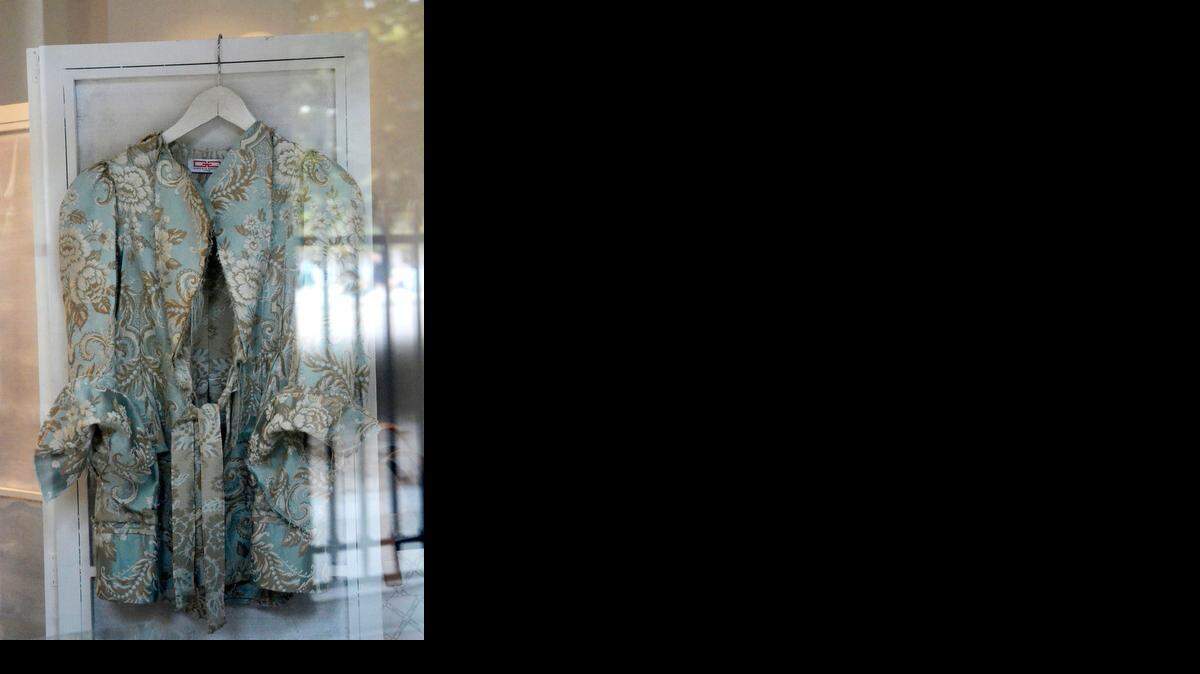 
This Aug. 22, 2014 photo shows a women's jacket in the window of the Gabrielle Geppart shop Lux & Vintage in the Palais Royal in Paris. Fashion, history and gardens. It’s an only-in-Paris experience at the Palais Royal, where luxury shops line the columned arcades of a 17th century palace. (AP Photo, Pamela Hassell) 
