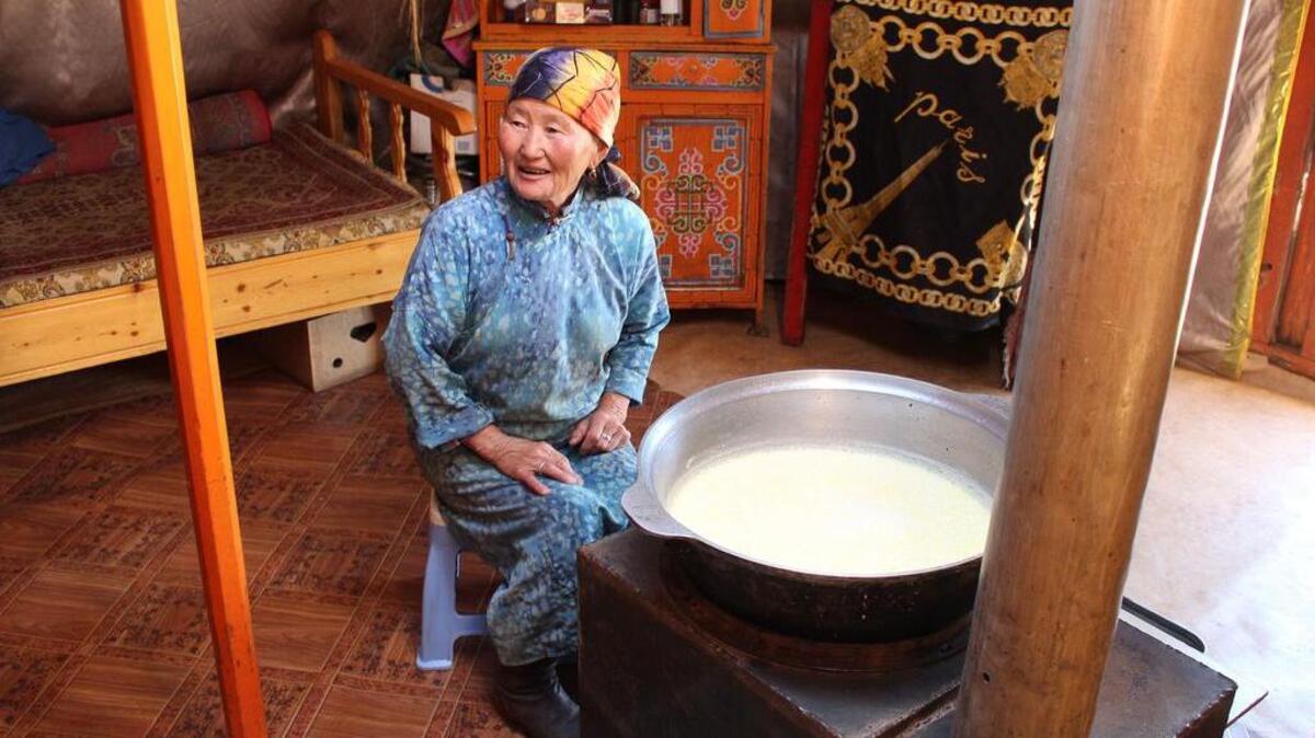 
Yandag, part of a herder family, sits next to a bowl of clotted cream she is making in her ger (yurt) near the Khogno Khan Uul Nature Reserve in central Mongolia.
