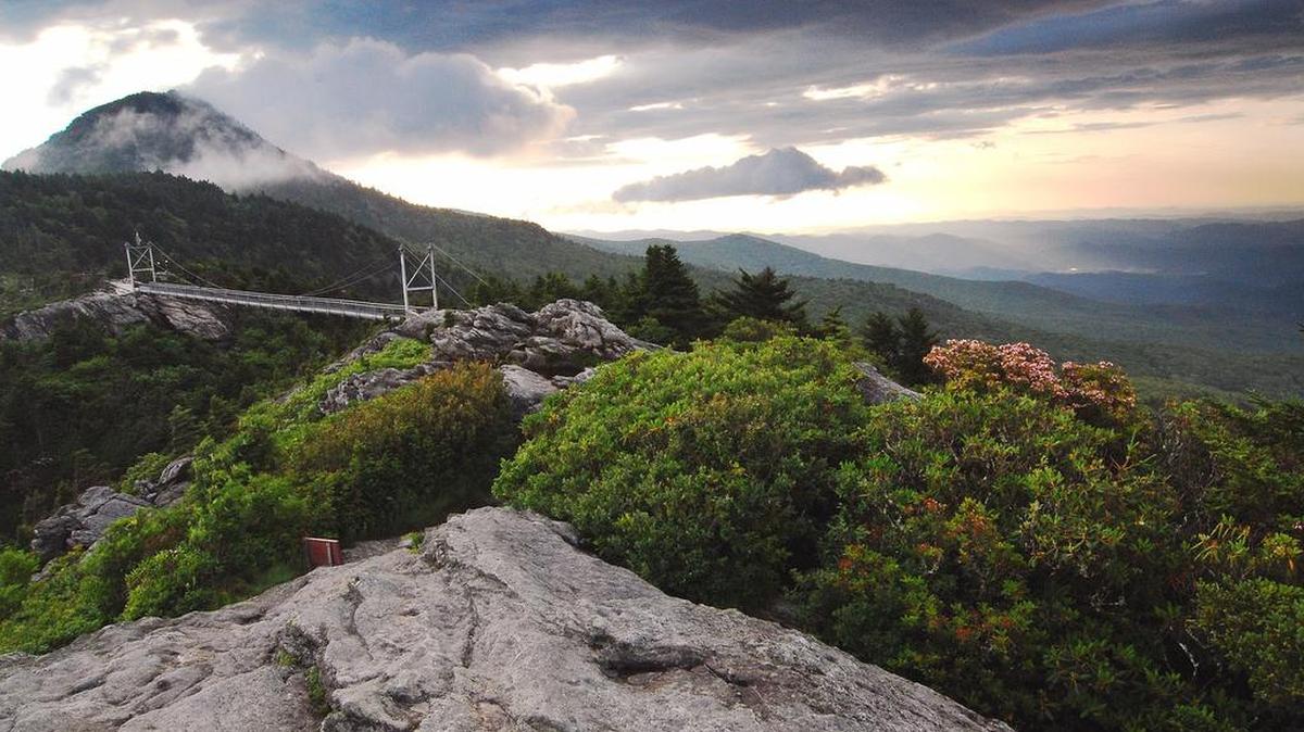 Grandfather Mountain’s Mile High Swinging Bridge hangs 5,280 feet above sea level between two of the mountain’s rocky peaks.