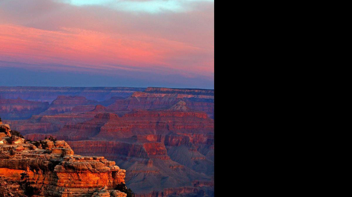 
The colors of a spring dawn paint the rock formations along the Grand Canyon’s South Rim near Mather Point. 


