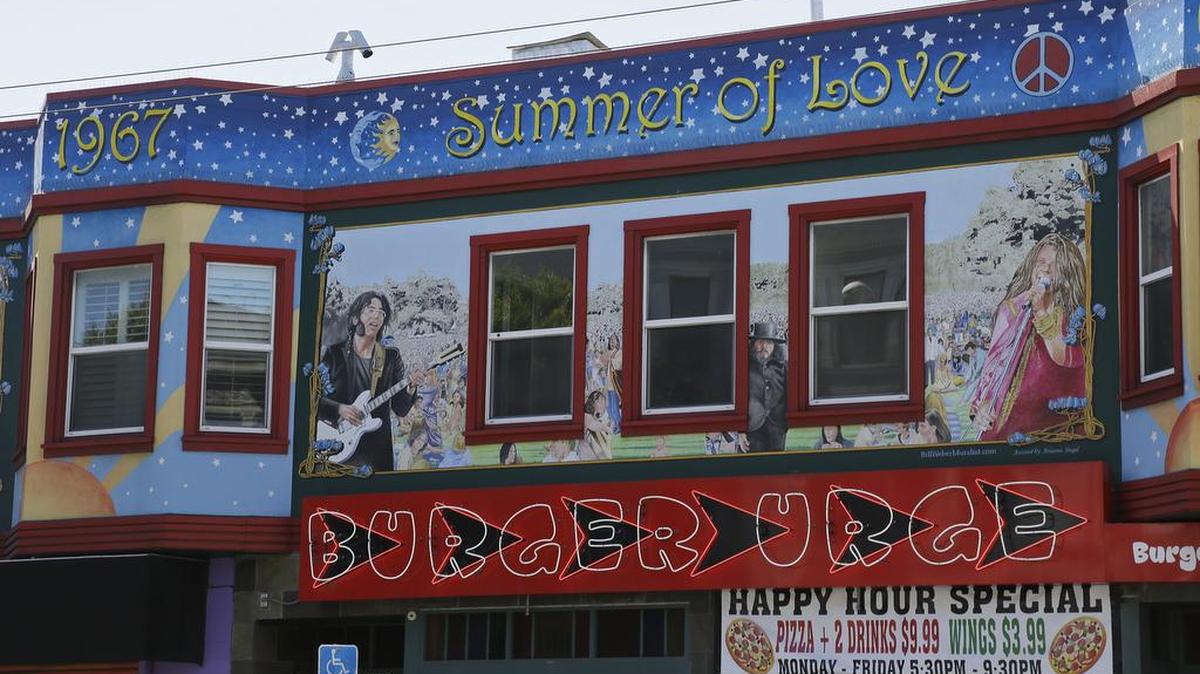 A building is painted in tribute to the 50th anniversary of the “Summer of Love” on Haight Street in San Francisco.