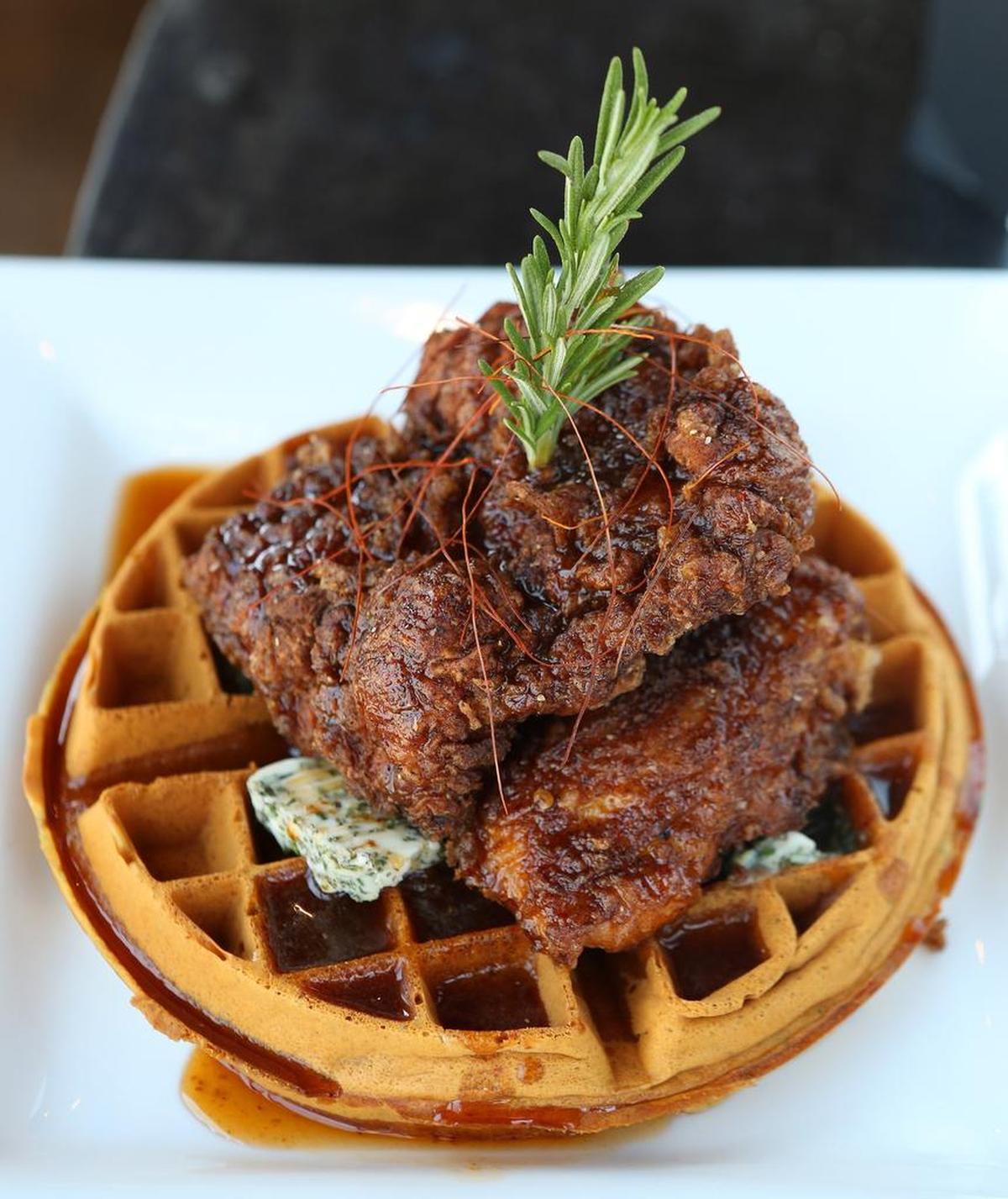 Chicken and waffles with rosemary and chipotle maple syrup at Fixture Kitchen and Social Lounge