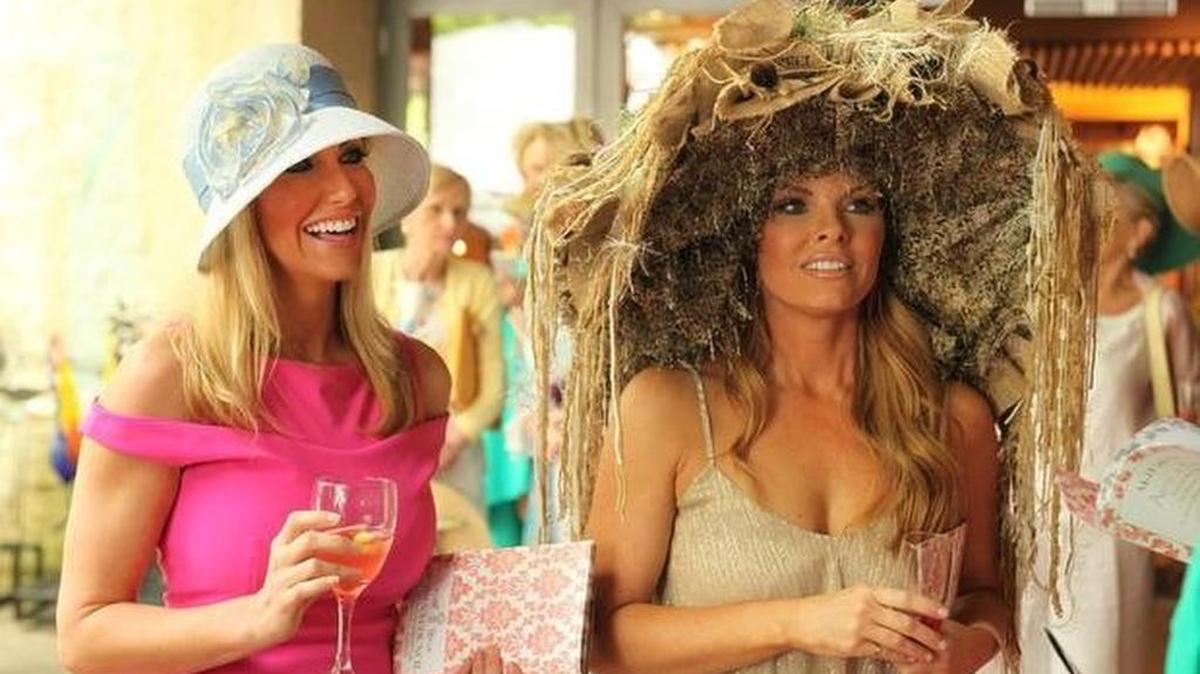 Stephanie Hollman and Brandi Redmond, with her turd-filled hat, at the Mad Hatters event at the Dallas Arboretum.