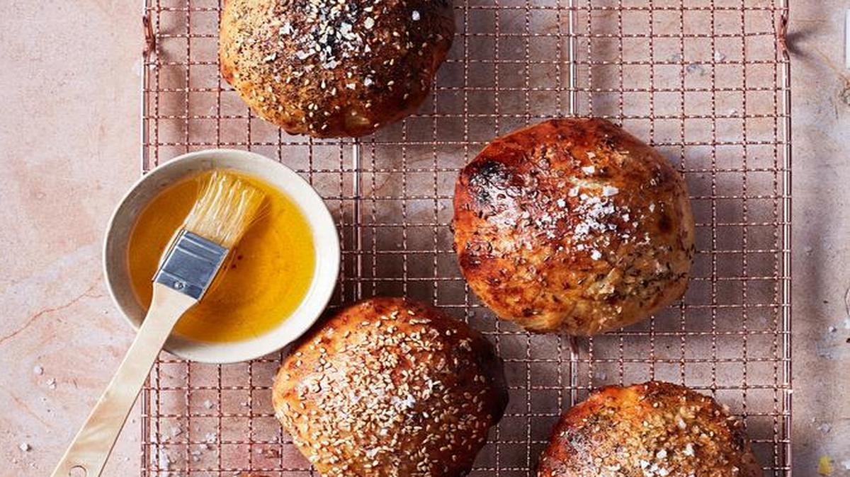 A tasty breakfast bread is lightly sweetened with medjool dates and garnished with toppings, including za’atar, and sesame and caraway seeds.