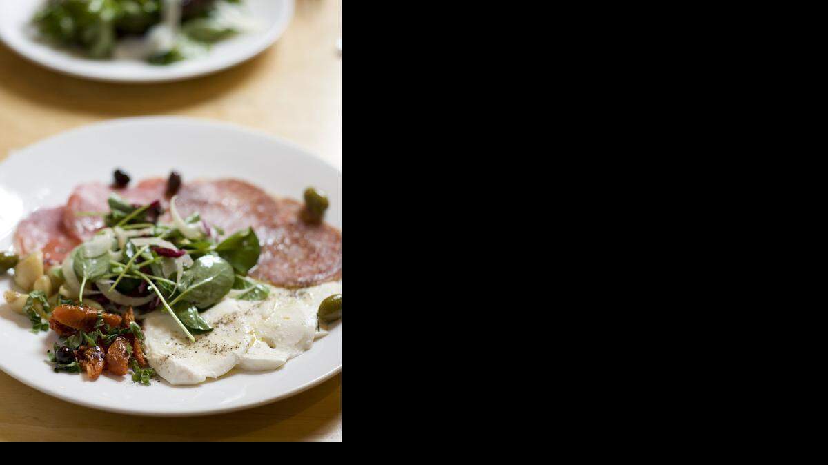 Andiamo Italian Restaurant is in Santa Fe’s historic Railyard District.<252><137> - Santa Fe, NM. Antipasti – house-made mozzarella, italian salamis, oven-dried tomatoes, roasted garlic, and marinated olives. Credit: Doug Merriam <137><137><252><137>