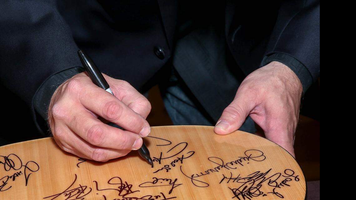
Garth Brooks signs a guitar during the ACM Lifting Lives Gala at the Dallas Omni
