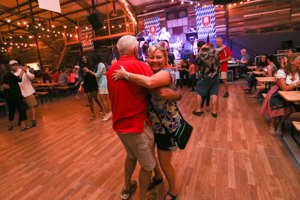A couple dances in one of the covered tents at Oktoberfest.