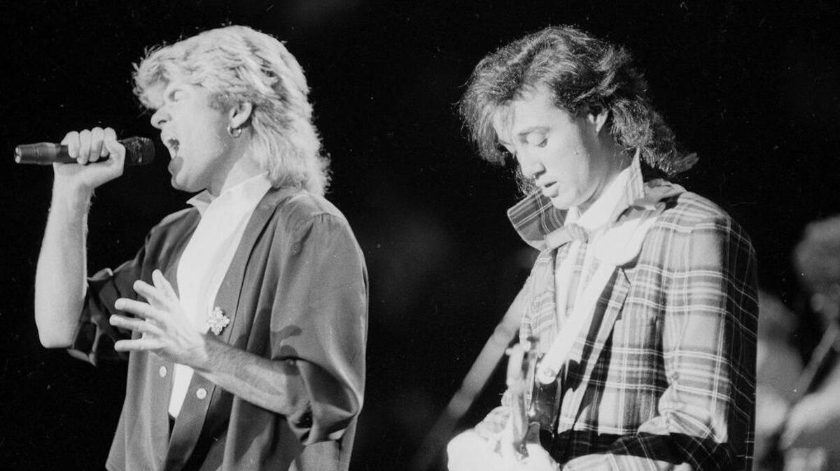 George Michael, left, and Andrew Ridgeley during a Wham! concert in Peking, China in 1985.