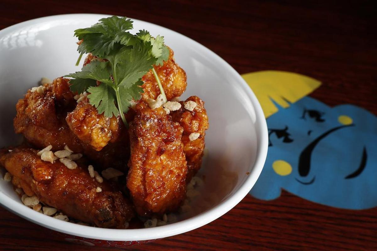 Crab-fat caramel wings — chicken wings rolled in crispy rice and dipped in crab paste, fish sauce and caramel — at Hot Joy in Dallas